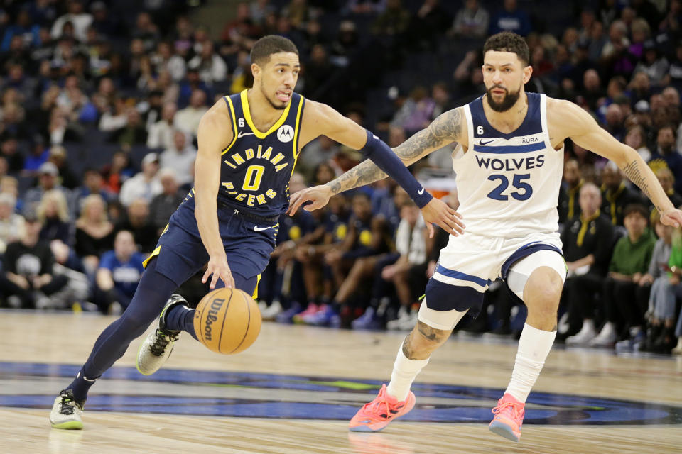 Indiana Pacers guard Tyrese Haliburton (0) drives on Minnesota Timberwolves guard Austin Rivers (25) in the third quarter of an NBA basketball game, Wednesday, Dec. 7, 2022, in Minneapolis. (AP Photo/Andy Clayton-King)