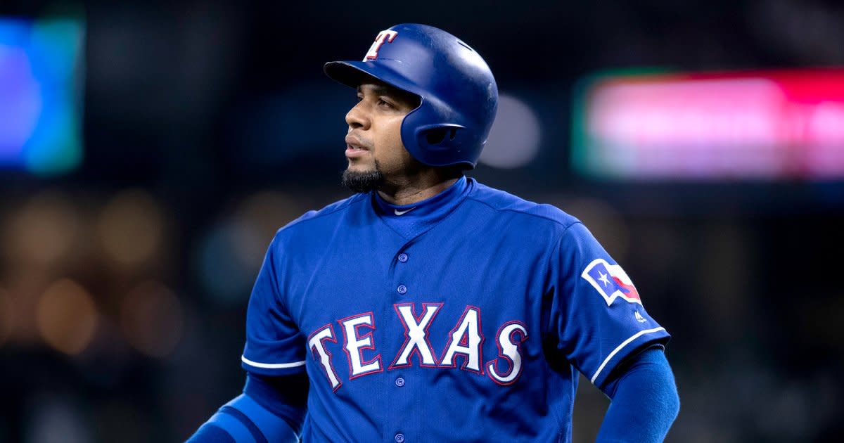 Texas Rangers' Elvis Andrus smiles as he looks on at play during a