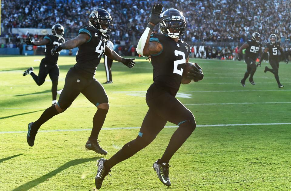 Jacksonville Jaguars safety Rayshawn Jenkins (2) runs into the end zone with teammates linebacker Josh Allen (41) and linebacker Devin Lloyd (33) after Jenkins intercepted a pass intended for Dallas Cowboys wide receiver Noah Brown (85) and runs in for a game-winning touchdown in overtime. The Jacksonville Jaguars hosted the Dallas Cowboys at TIAA Bank Field Sunday, December 18, 2022. The Jaguars trailed 21 to 7 at the half but came back to win 40 to 34 in overtime. [Bob Self/Florida Times-Union]