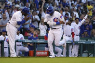 Chicago Cubs third base coach Willie Harris, left, greets Seiya Suzuki after Suzuki's home run off Washington Nationals starting pitcher Paolo Espino during the second inning of a baseball game Tuesday, Aug. 9, 2022, in Chicago. (AP Photo/Charles Rex Arbogast)