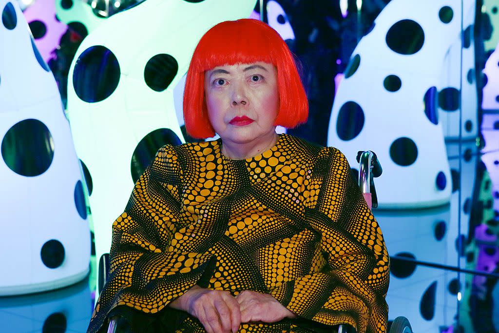 Artist Yayoi Kusama wearing her signature bright red wig