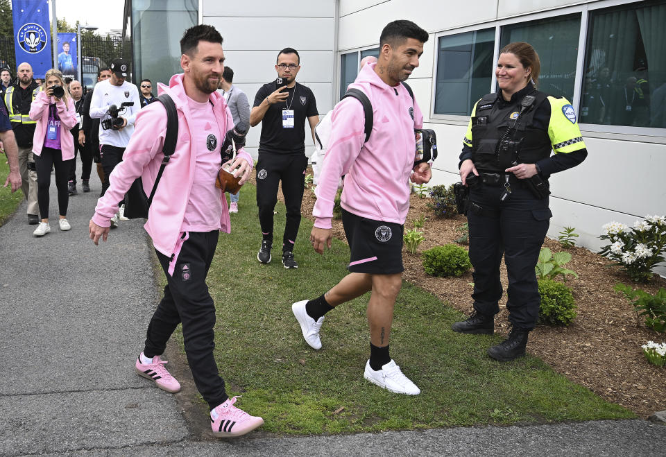 Inter Miami's Lionel Messi, left, and Luis Suarez arrive for the team's MLS soccer match gainst CF Montreal in Montreal, Saturday, May 11, 2024. (Graham Hughes/The Canadian Press via AP)