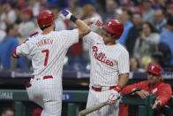 Philadelphia Phillies' Trea Turner (7) celebrates his home run off Colorado Rockies pitcher Ryan Feltner with J.T. Realmuto during the first inning of a baseball game Wednesday, April 17, 2024, in Philadelphia. (AP Photo/Matt Rourke)