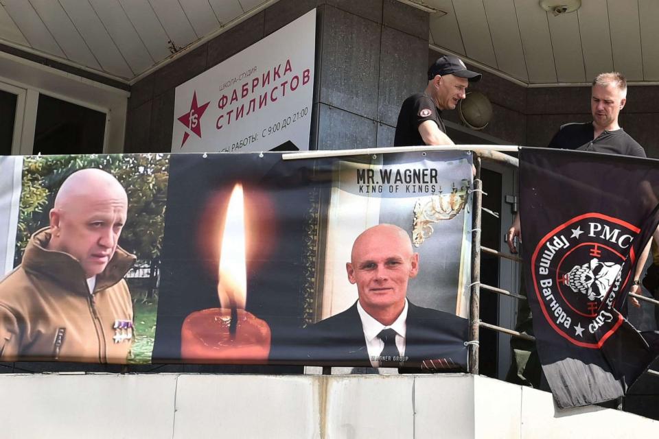 PHOTO: People hang out portraits of Yevgeny Prigozhin and Dmitry Utkin as they pay tribute to them at the makeshift memorial in front of the PMC Wagner office in Novosibirsk, on August 24, 2023. (Vladimir Nikolayev/AFP via Getty Images)