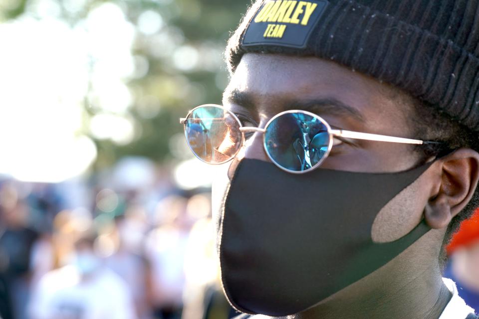 Emo Ismail, 18, watches a protest in honor of George Floyd on Thursday, May 28, 2020, in Minneapolis.