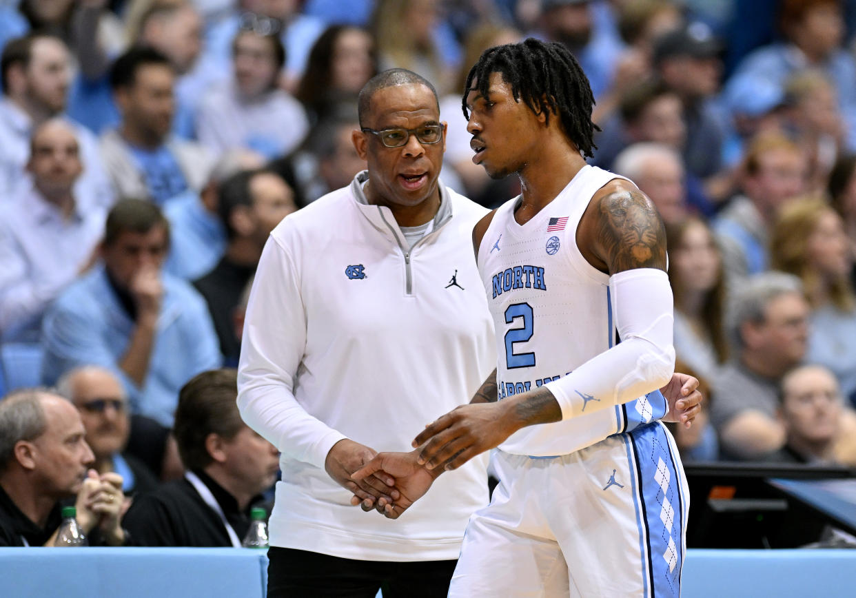 CHAPEL HILL, NORTH CAROLINA - FEBRUARY 11: Head coach Hubert Davis talks with Caleb Love #2 of the North Carolina Tar Heels during their game against the Clemson Tigers at the Dean E. Smith Center on February 11, 2023 in Chapel Hill, North Carolina. (Photo by Grant Halverson/Getty Images)