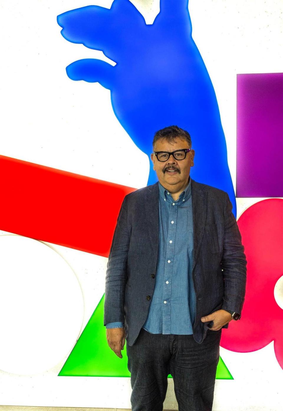 Gilbert Vicario, Chief Curator at Pérez Art Museum Miami, posed by the piece titled “ To live is to Die” by artist Typoe, on display at the museum, on Wednesday, September 20, 2023.