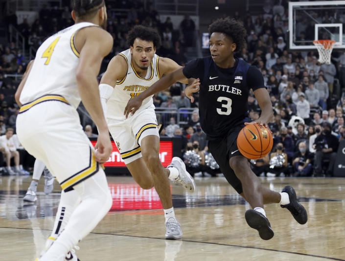 Butler guard Chuck Harris (3) drives past Providence forward Justin Minaya (15) during the second half of an NCAA college basketball game, Sunday, Jan. 23, 2022, in Providence, R.I. (AP Photo/Mary Schwalm)