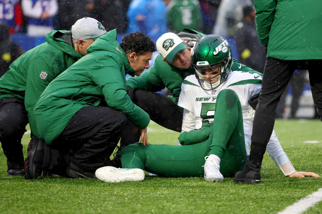 ORCHARD PARK, NEW YORK - DECEMBER 11: Mike White #5 of the New York Jets is looked at by the medical staff during the first half against the Buffalo Bills at Highmark Stadium on December 11, 2022 in Orchard Park, New York. (Photo by Timothy T Ludwig/Getty Images)