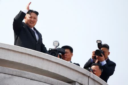 North Korean leader Kim Jong Un waves to people attending a military parade marking the 105th birth anniversary of country's founding father Kim Il Sung, in Pyongyang April 15, 2017. REUTERS/Damir Sagolj/Files