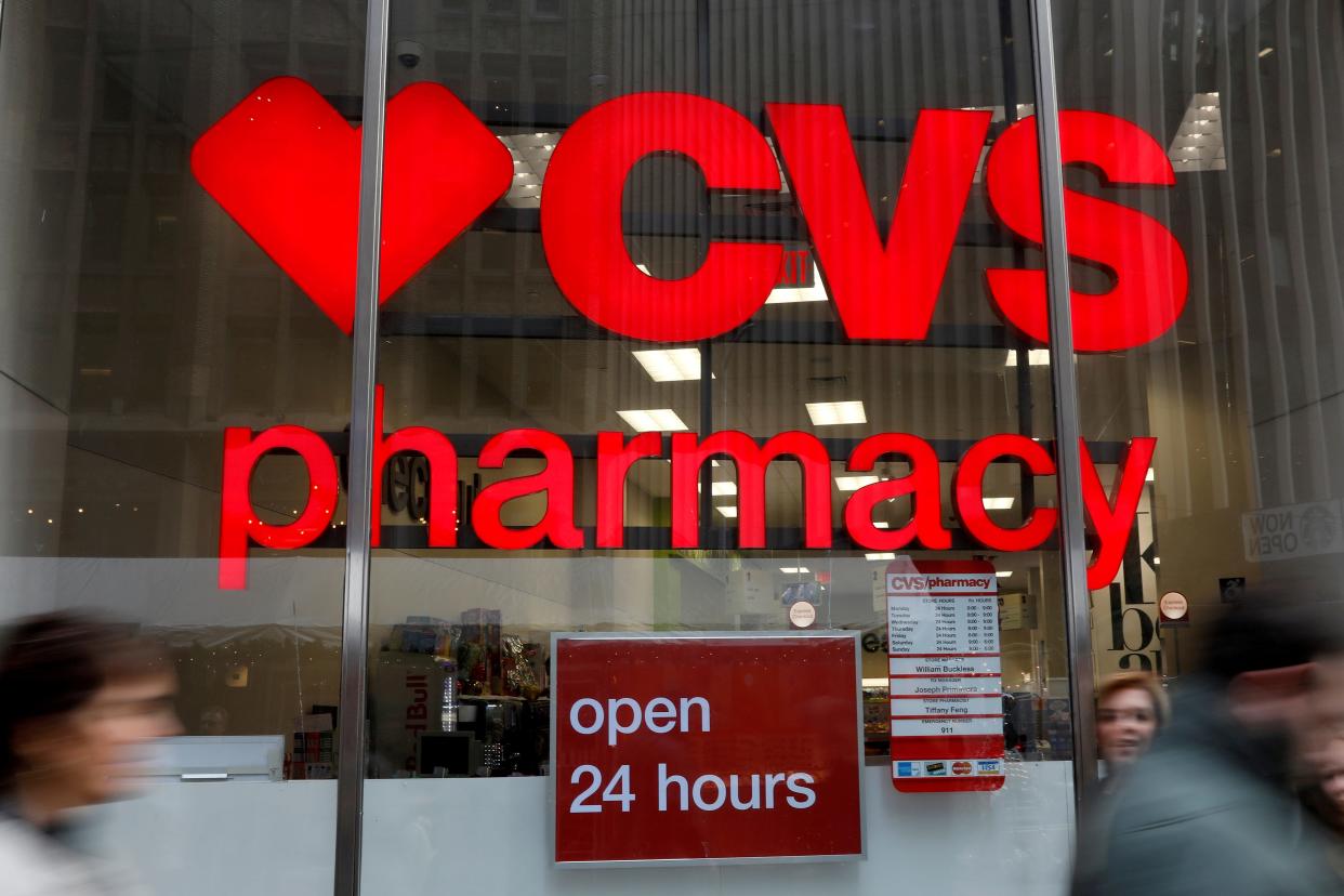 People walk by a CVS Pharmacy store in New York City.