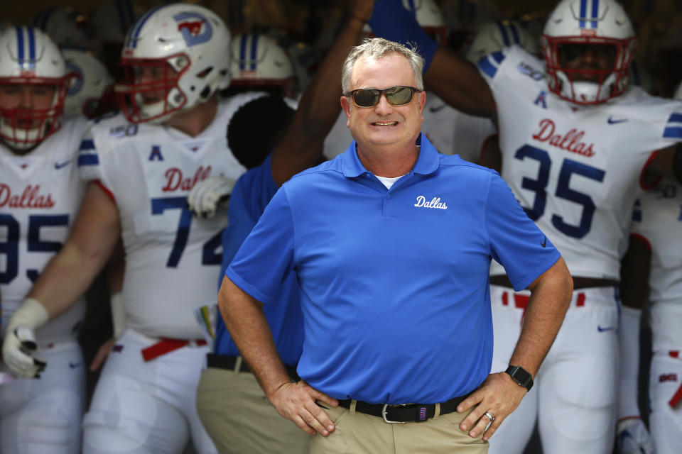 FILE - In this Sept. 21, 2019, file photo, SMU head coach Sonny Dykes waits with his team before playing TCU in an NCAA college football game, in Fort Worth, Texas. Shane Buechele is the starting quarterback for an undefeated Top 25 team, like so many people envisioned when he started 12 games as a true freshman for Texas. Except Buechele is now close to home after going to No. 19 SMU as a graduate transfer. Dykes is in a similar situation, back home in Texas as a head coach. (AP Photo/Ron Jenkins, File)