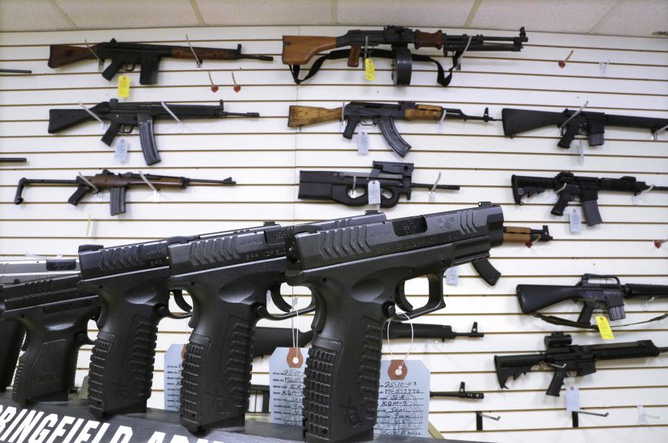 Assault weapons and hand guns are seen for sale at Capitol City Arms Supply, Jan. 16, 2013, in Springfield, Ill. Visa is pausing its decision to start categorizing purchases at gun shops, a significant win for conservative groups and 2nd Amendment advocates who felt that tracking gun shop purchases would inadvertently discriminate against legal firearms purchases.