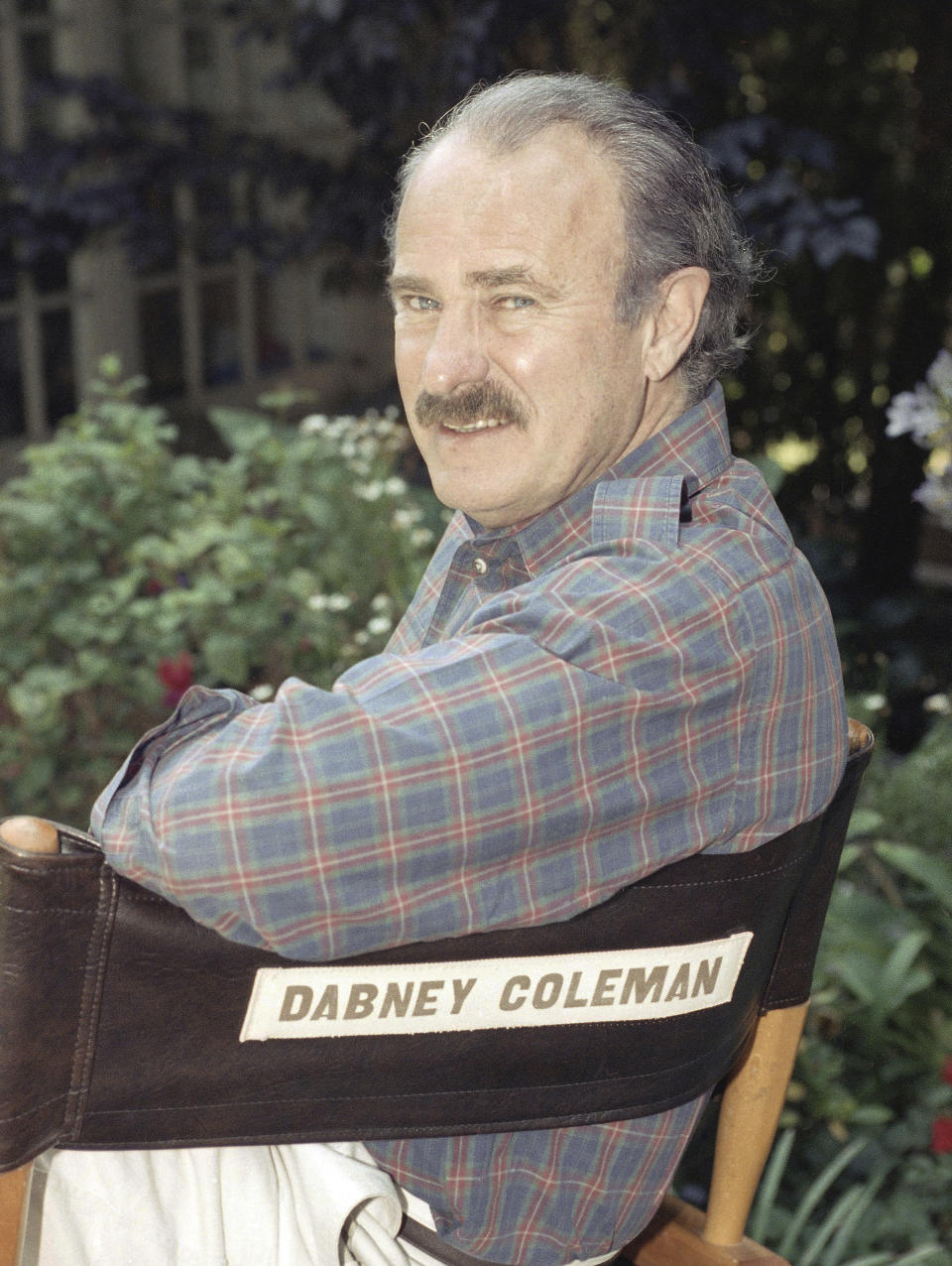 FILE - Actor Dabney Coleman poses at his home in Brentwood, Calif., Sept. 8, 1991. Coleman, the mustachioed character actor who specialized in smarmy villains like the chauvinist boss in "9 to 5" and the nasty TV director in "Tootsie," died Thursday, May 16, 2024, his daughter, Quincy Coleman, told The Hollywood Reporter. He was 92. No other details were immediately available. (AP Photo/Julie Markes, File)