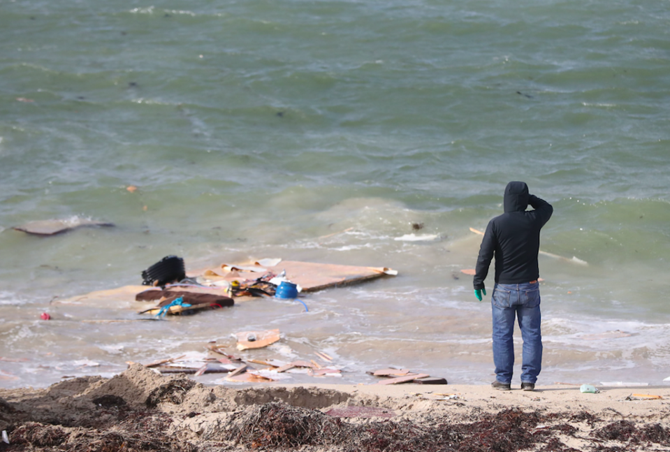 <em>A man looks at debris at the scene in Claddaghduff, near Clifden (PA)</em>