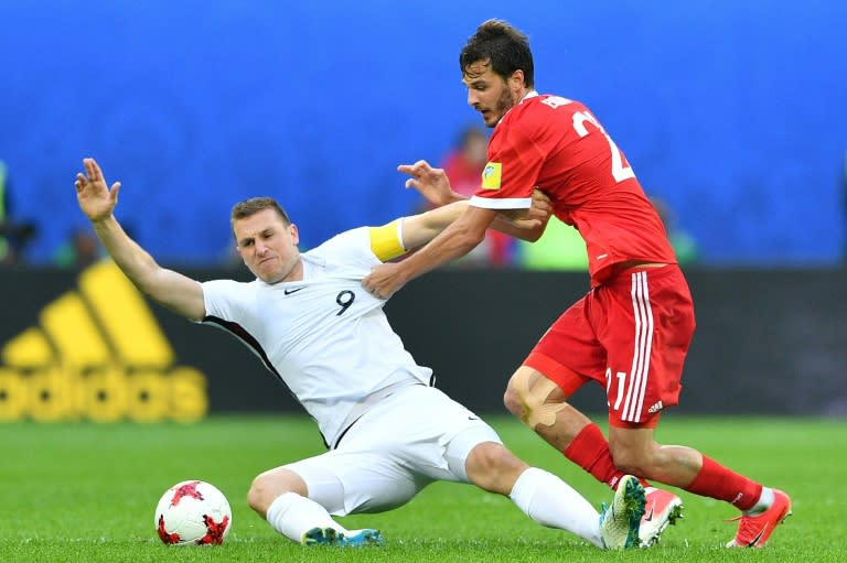 New Zealand's forward Chris Wood (L) is tackled by Russia's midfielder Alexander Erokhin during the 2017 Confederations Cup group A football match June 17, 2017
