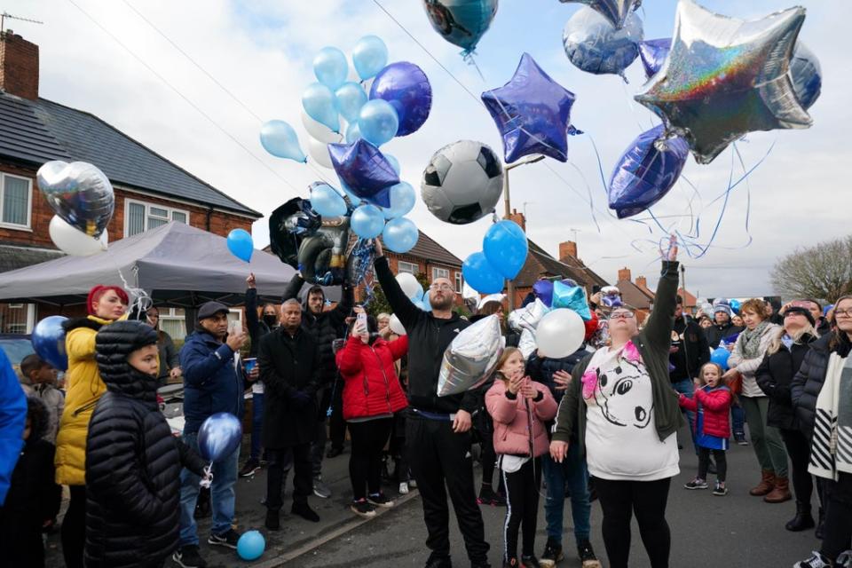 People release balloons during a tribute to six-year-old Arthur Labinjo-Hughes outside Emma Tustin’s former address in Solihull (Jacob King/PA) (PA Wire)