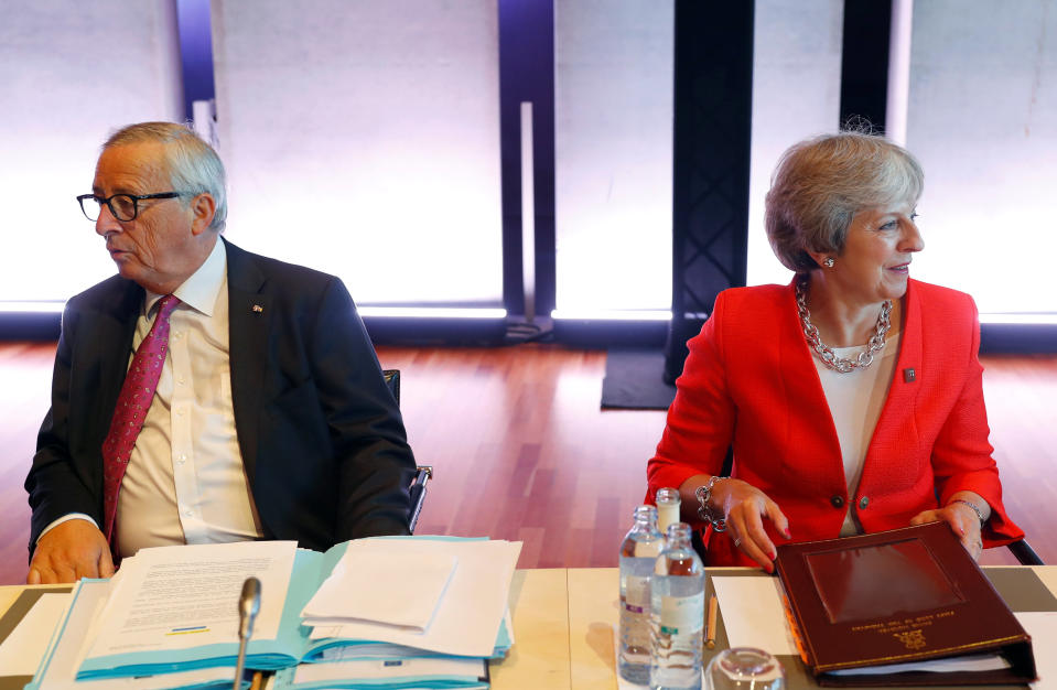 European Commission president Jean-Claude Juncker sitting next to prime minister Theresa May at the EU leaders’ summit in Salzburg (Reuters)