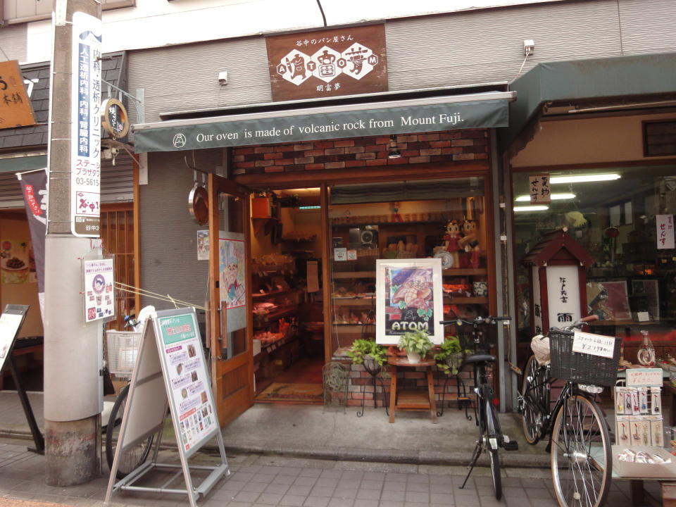 This Oct. 22, 2013 photo shows the Atom Bakery in the Yanaka neighborhood of Tokyo. Boasting an oven made of volcanic rock from Mt. Fuji, the bakery sells Western-style pastry such as croissants and is decorated with figures from the classic Astro Boy cartoon from which it takes its name. (AP Photo/Linda Lombardi)