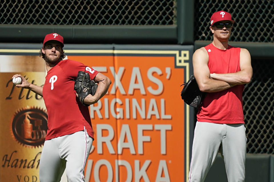 Philadelphia Phillies starting pitcher Aaron Nola, left, warms up ahead of Game 1 of the baseball World Series between the Houston Astros and the Philadelphia Phillies on Thursday, Oct. 27, 2022, in Houston. Game 1 of the series starts Friday. (AP Photo/David J. Phillip)