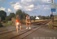 Shocking CCTV footage has been released which shows people risking their lives on level crossings - including a father and his young daughter posing for a photo shoot. The reckless father can be seen taking pictures of the little girl - who appears to be of primary school age - in different directions on the crossing. Their car can be seen in the background with its doors open as the youngster adopts various poses and occasionally looks behind her for approaching trains. Another shocking clip captured on CCTV shows a group of cyclists who dismount their bikes and line up for a group photo on the crossing.