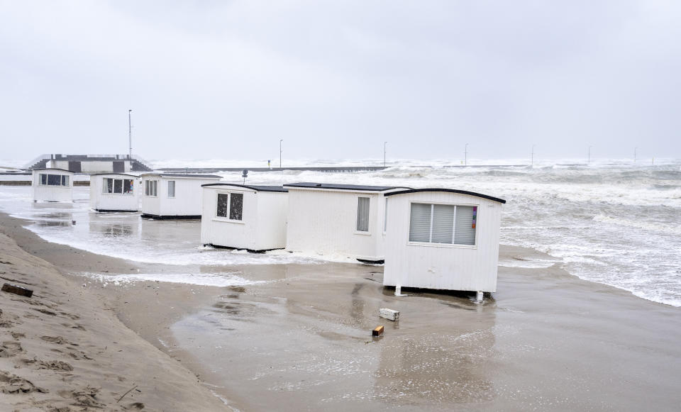 Picnic cabins get flooded in the water of the North Sea in the strong winds in Loekken, Denmark, Tuesday, Aug. 8, 2023. (Henning Bagger/Ritzau Scanpix via AP)