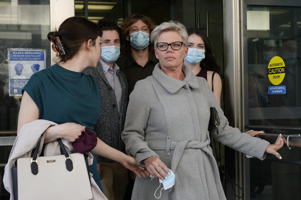 Nicole Reffitt, center, walks out of federal court in Washington on March 8, 2022. Her husband, Guy, was convicted on charges stemming from the Jan. 6, 2021, insurrection. 