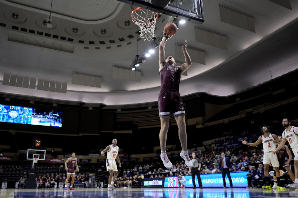 Freed-Hardeman forward Peyton Law (2) puts up a shot during the first half of the NAIA men's national championship college basketball game against Langston, Tuesday, March 26, 2024, in Kansas City, Mo. (AP Photo/Charlie Riedel)
