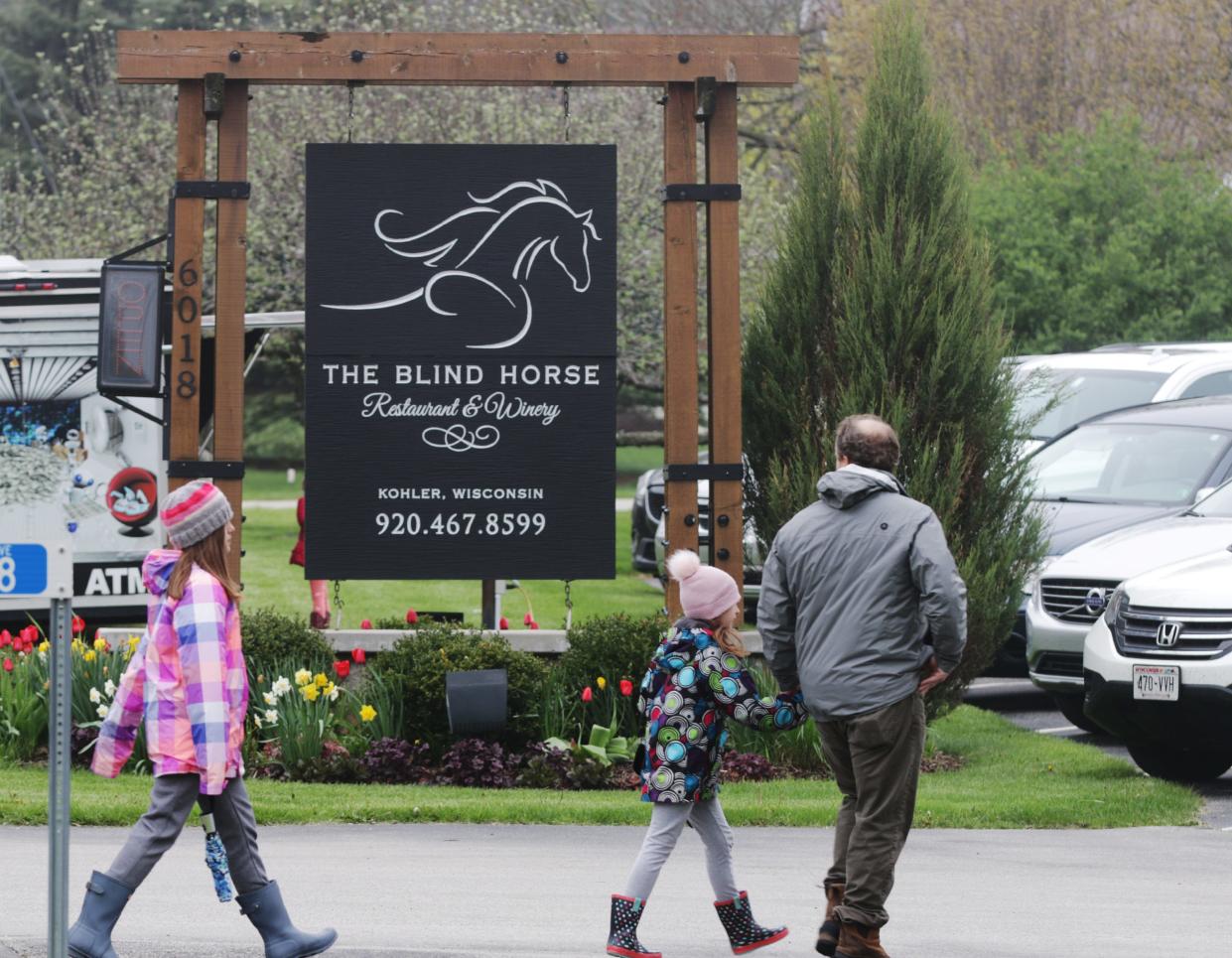 People enter the Blind Horse Food Truck Festival, Saturday, May 18, 2019, in Kohler, Wis.