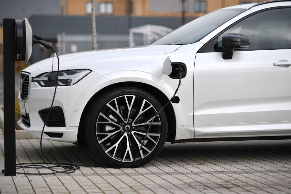 Volvo XC60 hybrid plugged into a charger