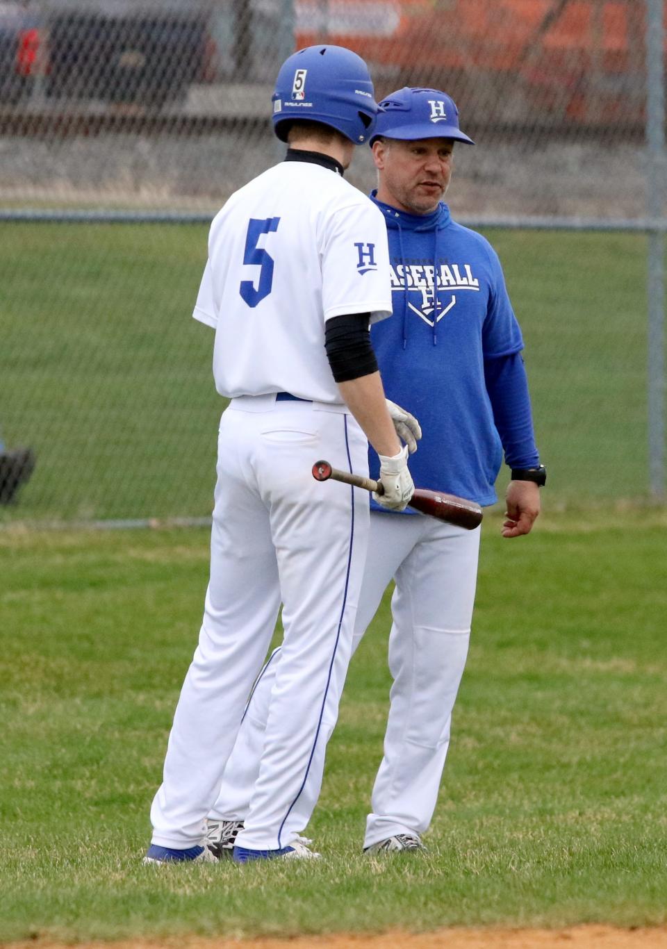 Horseheads head coach Jeff Limoncelli talks with Dylan Ribble during the Blue Raiders' 4-1 win over Union-Endicott in baseball April 6, 2022 at Horseheads High School.