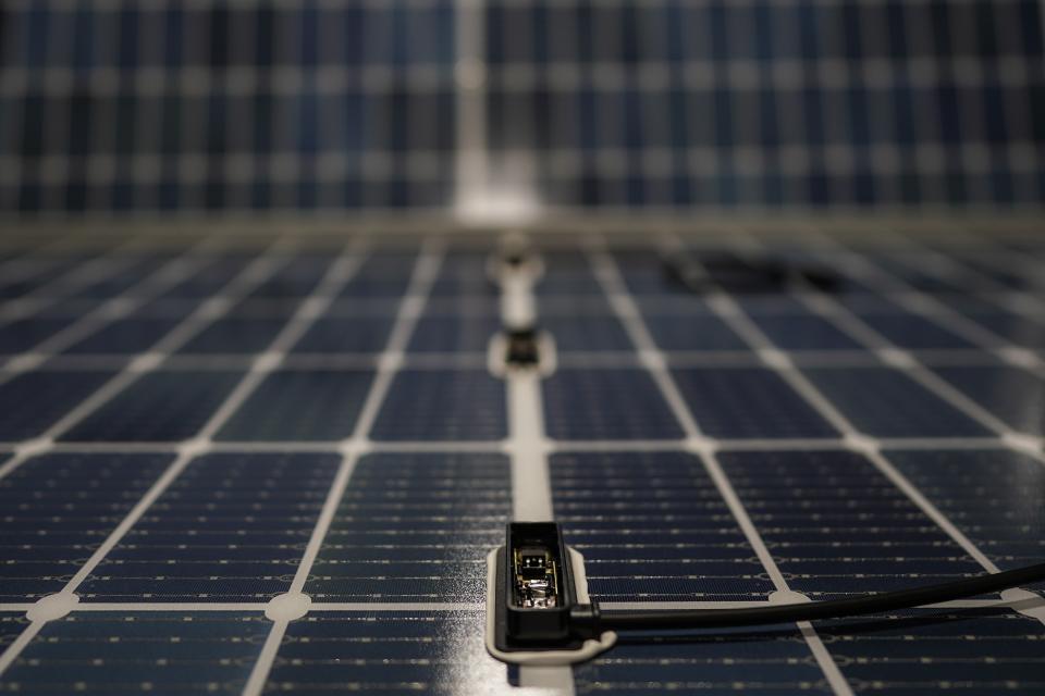 A power connection is seen on a solar panel inside the Hanwha Qcells Solar plant, Monday, Oct. 16, 2023, in Dalton, Ga. The Korean company is opening what it says is the first solar panel factory to begin production in the U.S. since the passage of President Joe Biden’s signature climate legislation. (AP Photo/Mike Stewart)