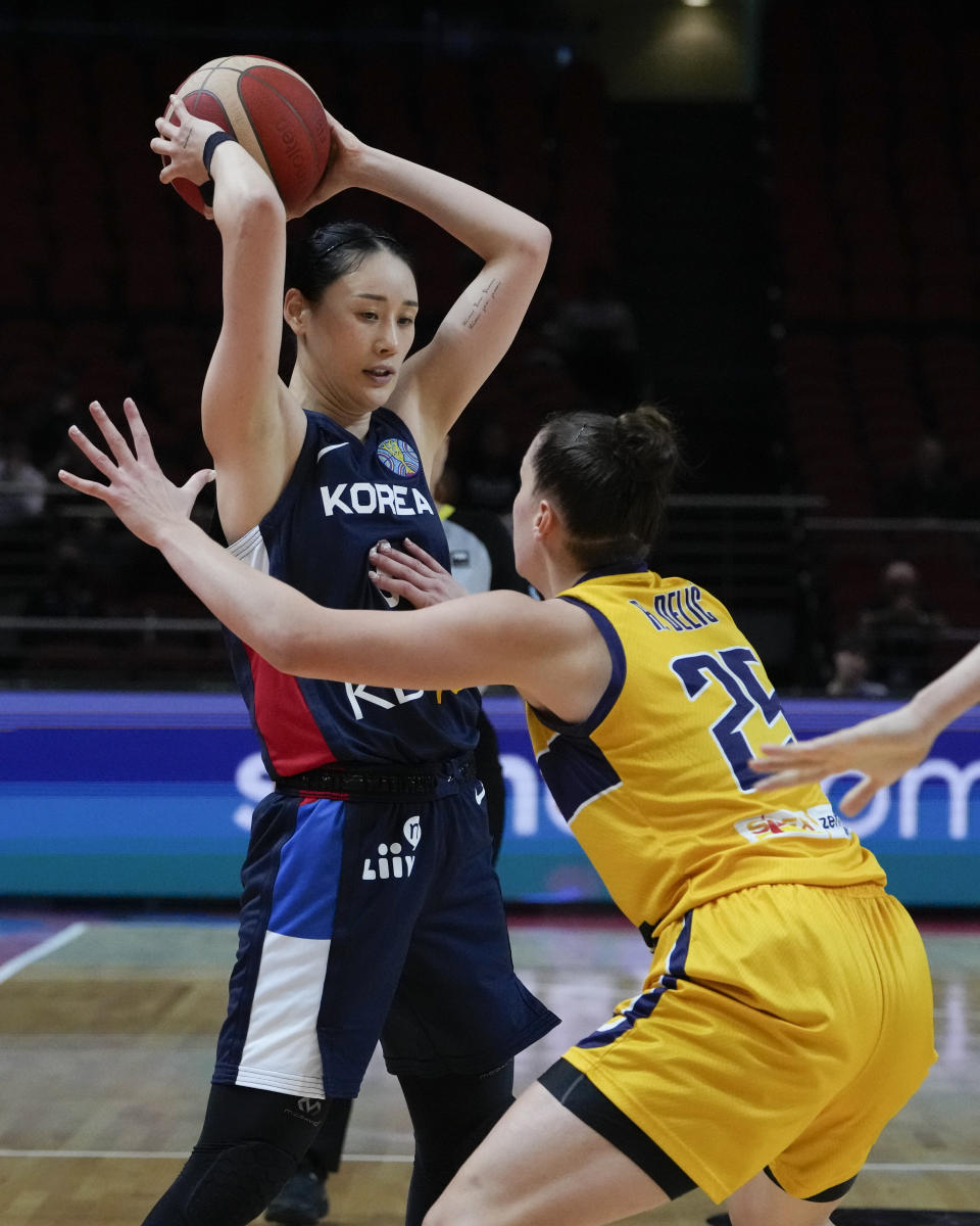 South Korea's Kang Leeseul looks to pass the ball past Bosnia and Herzegovina's Andela Delic during their game at the women's Basketball World Cup in Sydney, Australia, Saturday, Sept. 24, 2022. (AP Photo/Mark Baker)