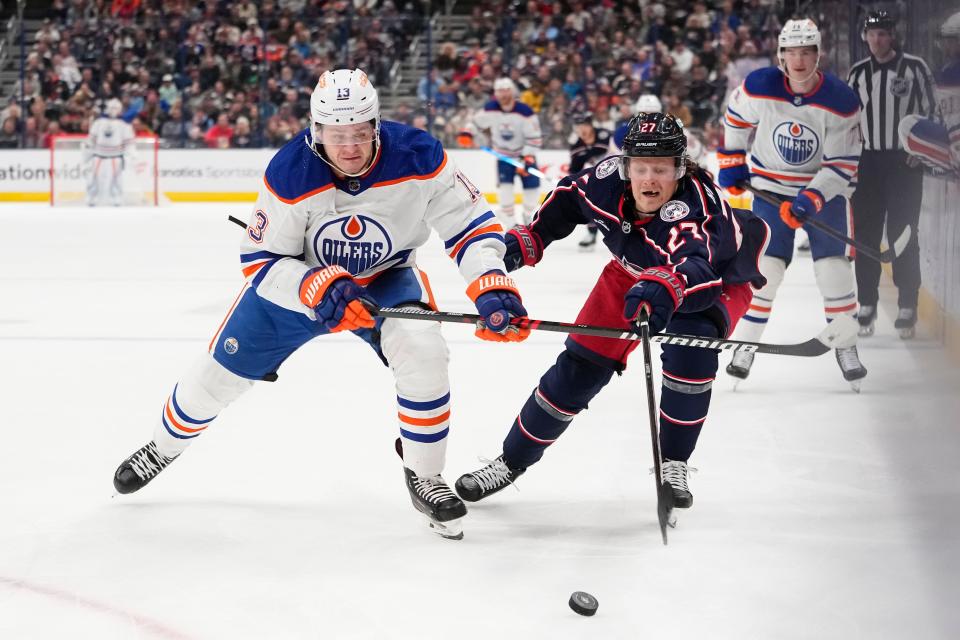 Mar 7, 2024; Columbus, Ohio, USA; Columbus Blue Jackets defenseman Adam Boqvist (27) races Edmonton Oilers center Mattias Janmark (13) to the puck during the second period of the NHL hockey game at Nationwide Arena.