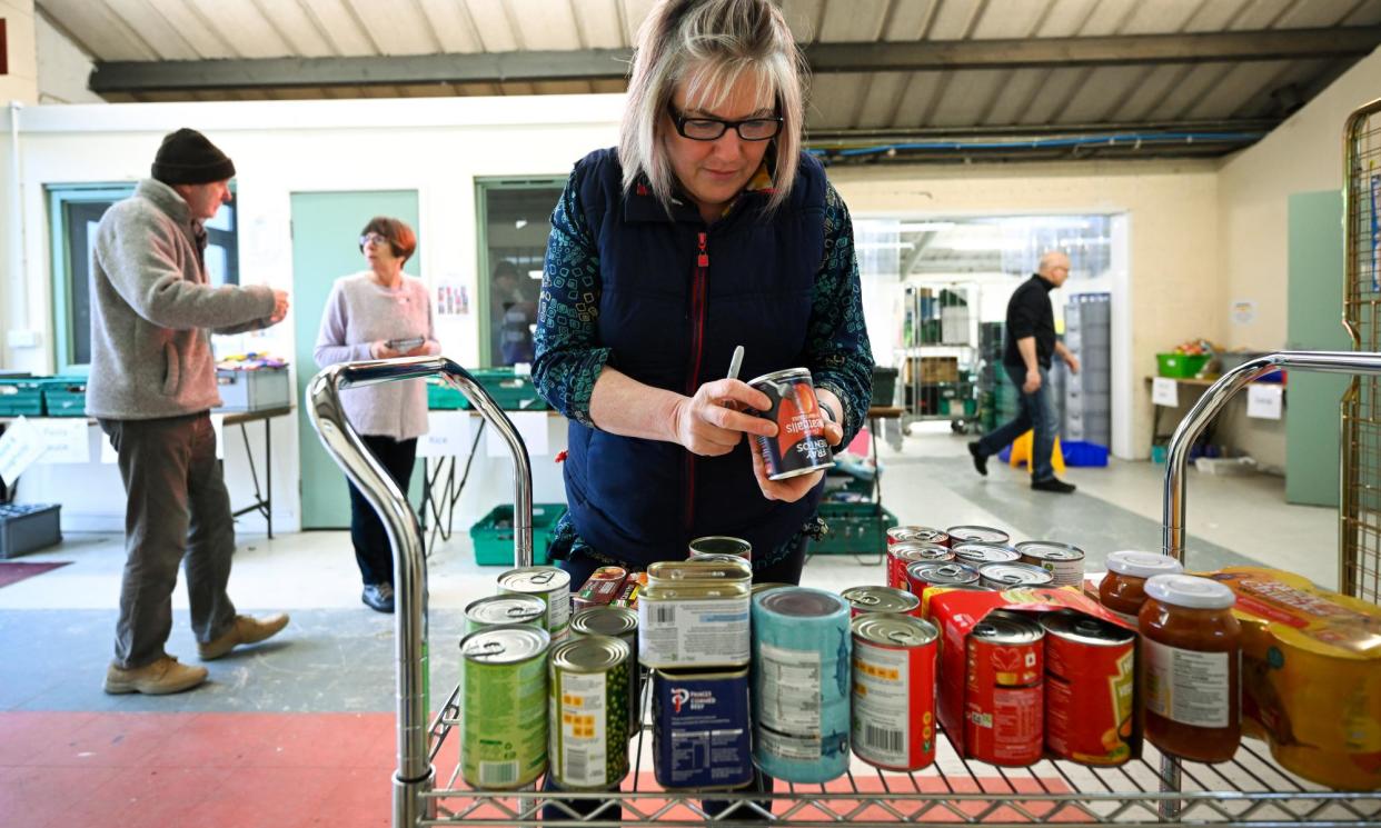 <span>Volunteers at a food bank in Weymouth, England.</span><span>Photograph: Finnbarr Webster/Getty Images</span>