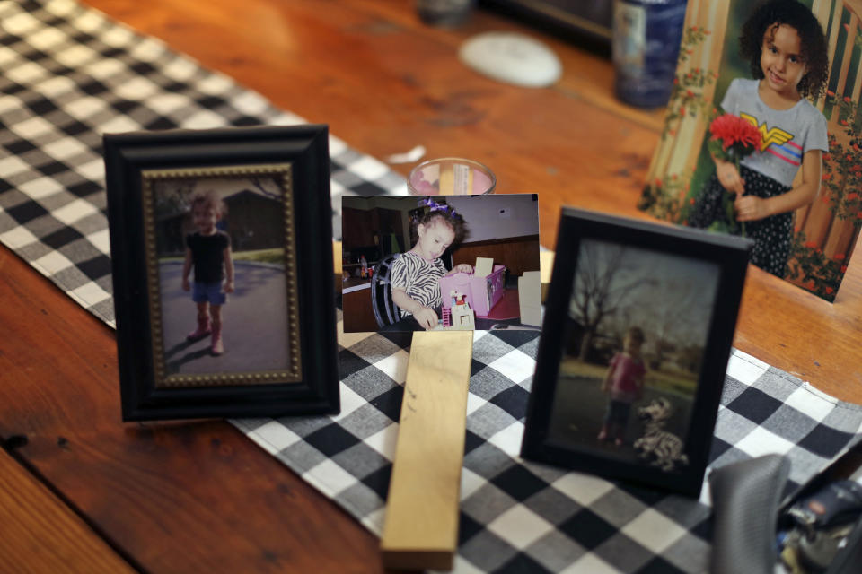 Photos of Layla Salazar are displayed on a table of her home in Uvalde, Texas Thursday, May 26, 2022. Layla Salazar was one of the 19 children and their two teachers who were gunned down behind a barricaded door at Robb Elementary School. Each morning as he drove her to school in his pickup, Salazar would play "Sweet Child O' Mine," by Guns N' Roses and they'd sing along, he said. (AP Photo/Dario Lopez-Mills)