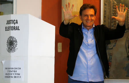 Senator Marcelo Crivella, candidate for Rio de Janeiro mayor, gestures to photographers after voting during the municipal elections at a polling station in Rio de Janeiro, Brazil, October 30, 2016. REUTERS/Ricardo Moraes