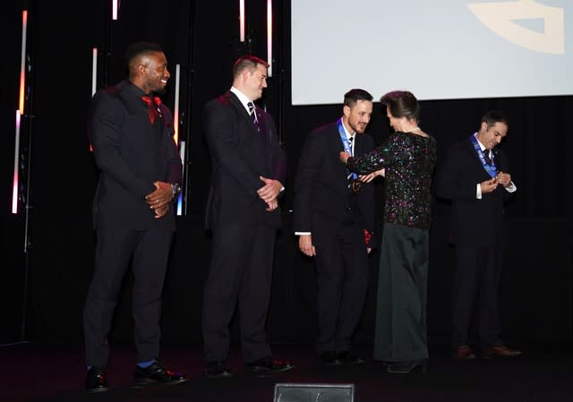 Princess Anne giving the team their medals