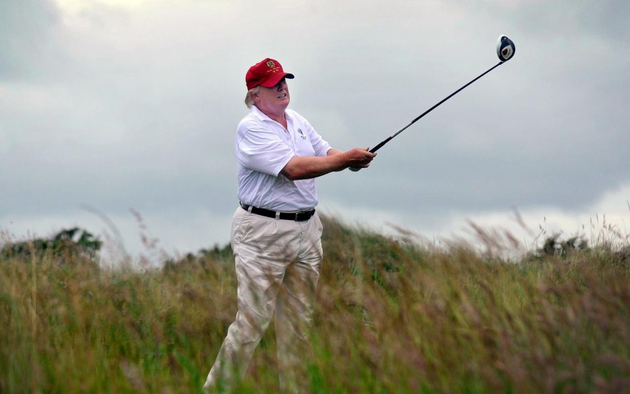 US tycoon Donald Trump plays a stroke as he officially opens his new multi-million pound Trump International Golf Links course in Aberdeenshire, Scotland, on July 10, 2012. Work on the course began in July 2010, four years after the plans were originally submitted. AFP PHOTO / Andy Buchanan (Photo by Andy Buchanan / AFP) (Photo by ANDY BUCHANAN/AFP via Getty Images) - ANDY BUCHANAN/AFP via Getty Images