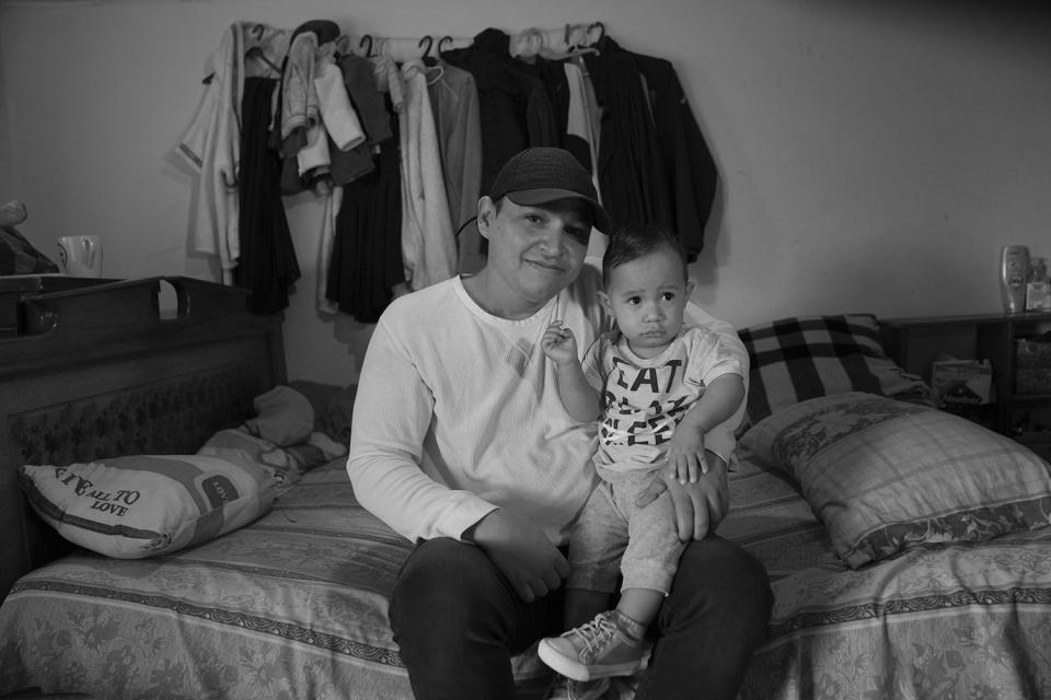 HOLD FOR DARIO LOPEZ - Ali Mora, from Venezuela, poses for a portrait with his son Benjamin in the room he rents for his Ecuadorian wife in Tumbaco, Ecuador, Thursday, Feb. 23, 2023. The former hospital worker's mother is also in Ecuador, his father and grandmother are in Venezuela and his other sister is in the U.S. (AP Photo/Dolores Ochoa)