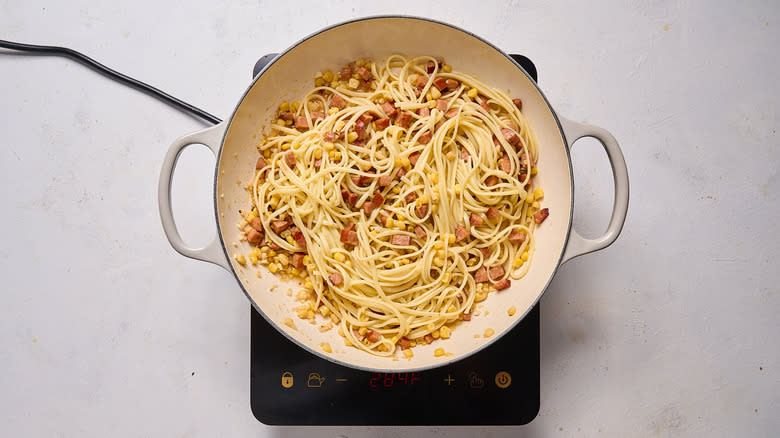 corn and sausage pasta in skillet