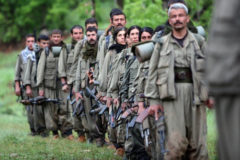 Kurdistan Workers' Party (PKK) fighters arrive in the northern Iraqi city of Dohuk on May 14, 2013. The first group of Kurdish fighters leaving Turkey as part of a peace drive with Ankara have arrived to handshakes and embraces in Iraqi Kurdistan after a gruelling week-long journey