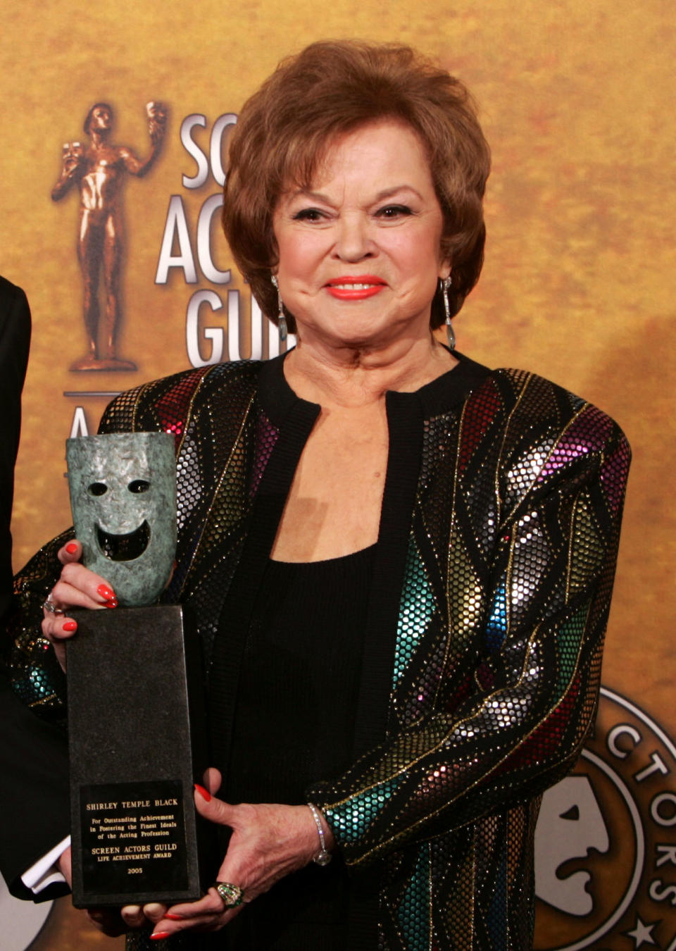 FILE - In this Jan. 29, 2006 file photo, Shirley Temple Black poses with the Screen Actors Guild Awards 42st annual life achievement award at the 12th Annual Screen Actors Guild Awards, in Los Angeles. Shirley Temple, the curly-haired child star who put smiles on the faces of Depression-era moviegoers, has died. She was 85. (AP Photo/Reed Saxon, File)