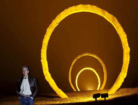 Thomas Sayre, the great grandson of U.S. President Woodrow Wilson, poses for a photograph in front of his sculpture installation entitled "Gyre" in Raleigh, North Carolina, December 1, 2015. REUTERS/Jonathan Drake