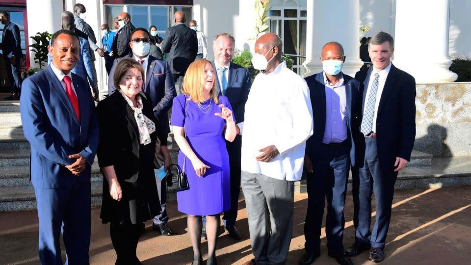 Family Watch International founder Sharon Slater (in purple) is pictured with Ugandan President Yoweri Museveni (wearing a face mask) outside Uganda's State House in April during a conference on so-called "family values." - From National Reistance Movement