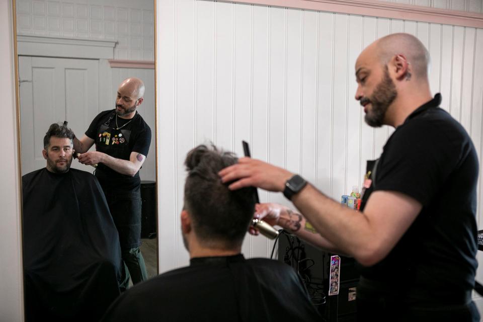 Independent Hair Stylist Gregory Routt styles the hair of Bryan Davis, of Chillicothe, at Salon Niche on April 13, 2023, in Chillicothe, Ohio. Routt is registering his business with an organization called "Strands fo Trans" which allows those who identify as LGBTQIA+, and allies, look online for safe places where they can come feel welcomed within the community. Gregory said he just wants to provide a place where people can feel their most authentic selves.