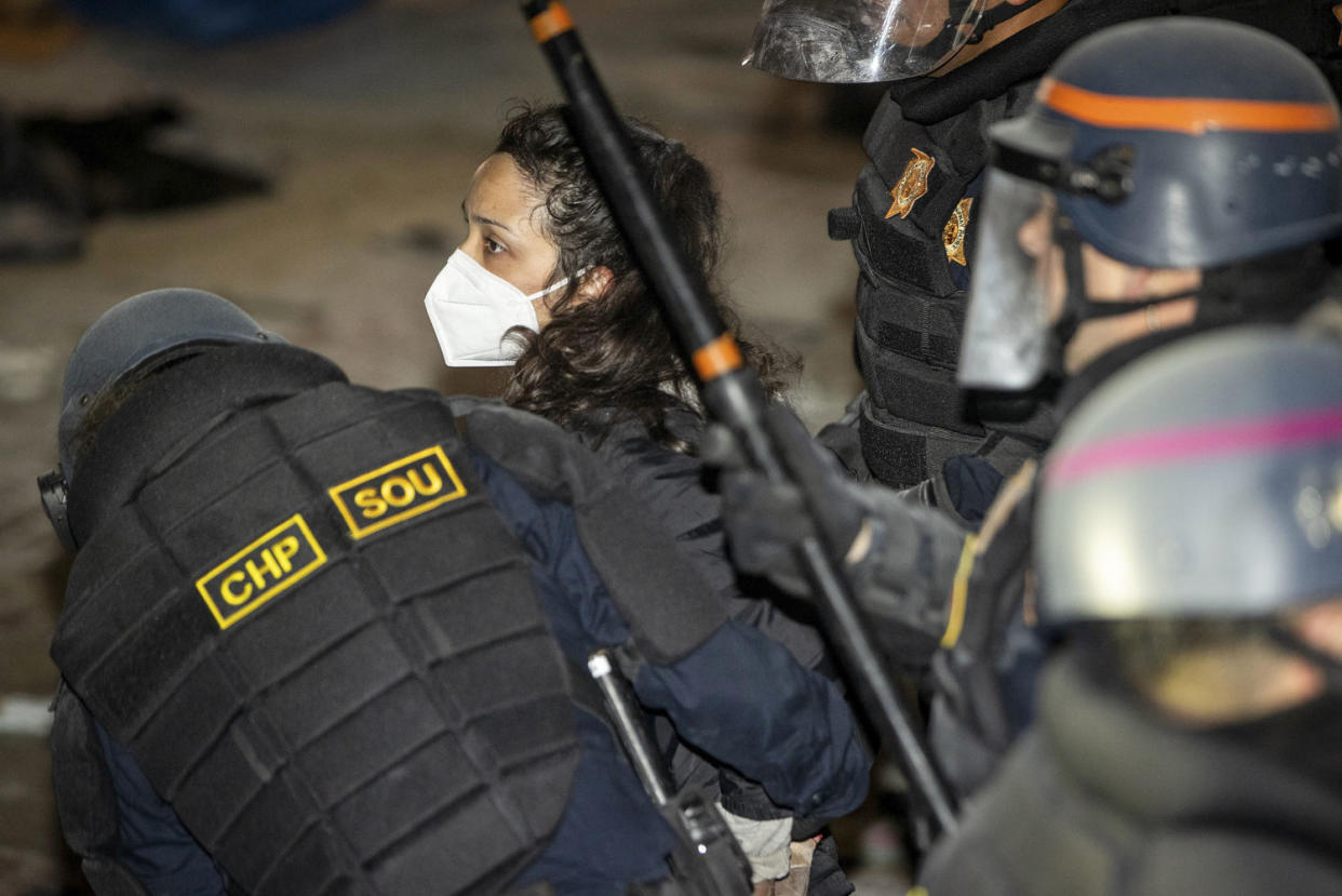 Police detain a demonstrator  (Ethan Swope / AP)