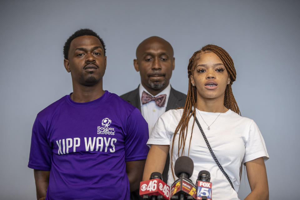 Attorney Mawuli Davis, center, stands with his clients, Charmaine Turner, right, and Secoriey Williamson, parents of Secoriea Turner, as they speak during a press conference to announce a lawsuit against the city of Atlanta and others for a series of actions that resulted in the death of their 8-year-old daughter, Monday, June 7, 2021. (Alyssa Pointer/Atlanta Journal-Constitution via AP)