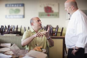 Angry customer complaining to chef in restaurant