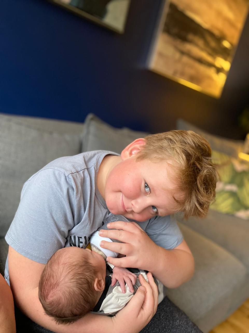 Meagan Edwards says the cost of formula has gone up dramatically since her now seven-year-old son Callum was a baby. Callum is seen here feeding his little sister Cecelia.
